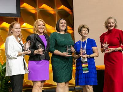 Five women holding CREW Impact awards