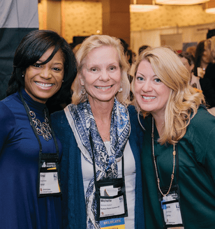 Three women volunteering at CREW Network event