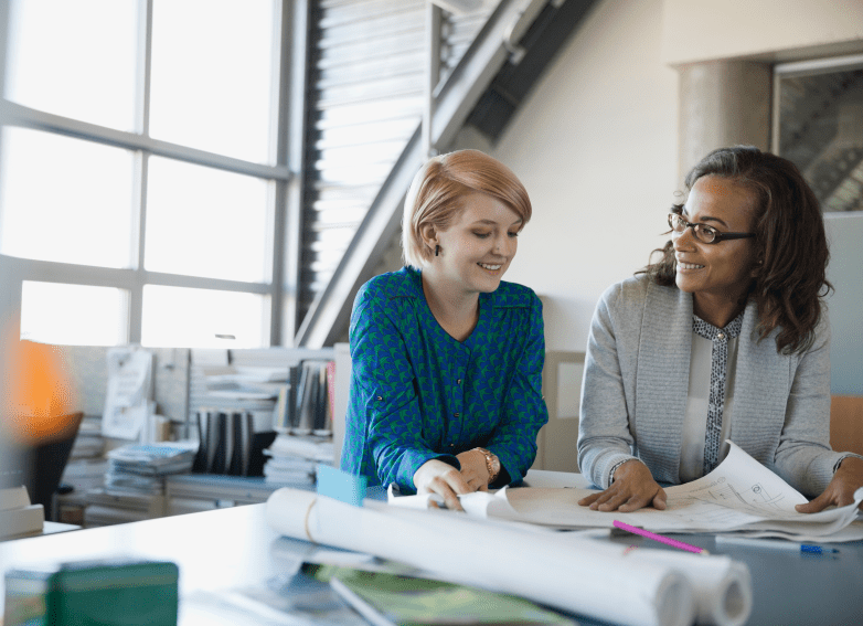 woman mentoring using blueprints
