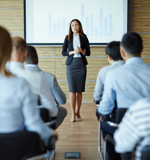 Female teacher or speaker explaining project to managers