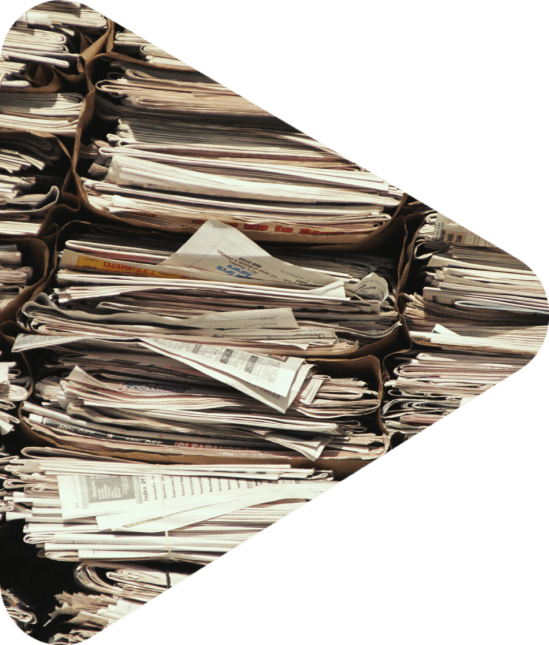 Several Stacks of newspapers lined up against a wall